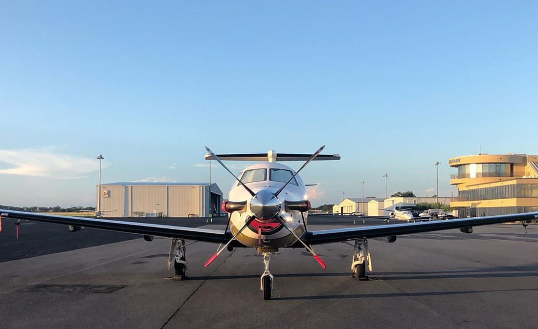 The front view of a Pilatus PC-12 aircraft, part of the Tryp Air Charter fleet.