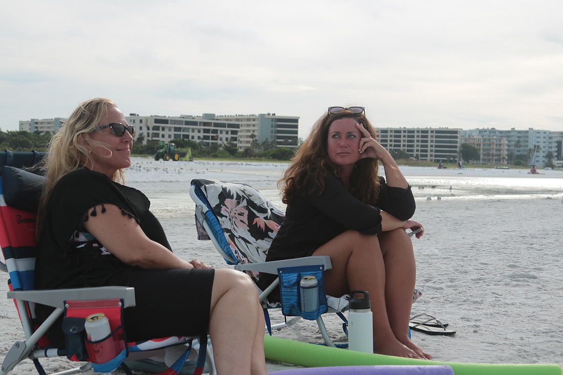 Kimberly Ramalho, left, and Katie Capone sit on Siesta Key Beach Wednesday, Sept. 25. The two friends were enjoying the weather a day before Hurricane Helene is due to pass by on the way to a predicted landfall in the Big Bend area of Florida.