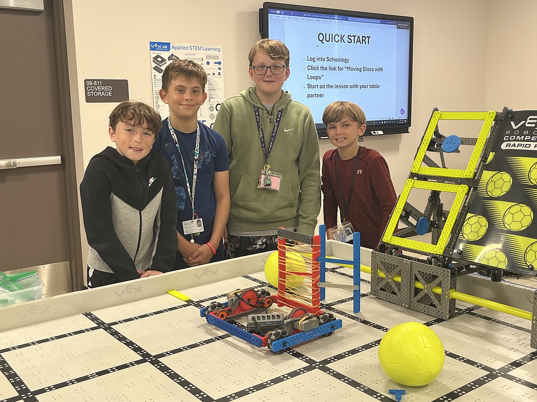 Carlos E. Haile Middle School students Brayden Berggren, Cord London, Kase Alsum and Levi Rear take advantage of the new robotics arena in the technology lab.