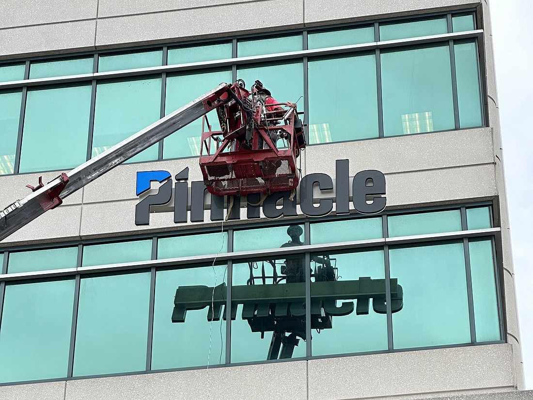 Taylor Sign & Design Inc. of Jacksonville installs the Pinnacle sign Sept. 25  at 501 Riverside Ave.