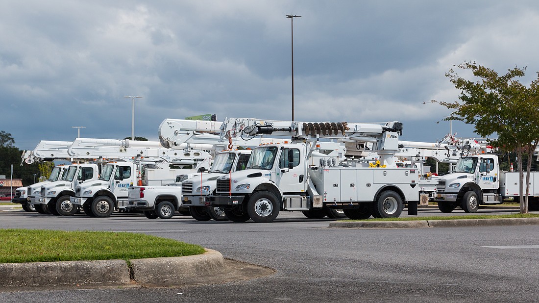 Electric utility repair trucks. Photo courtesy of tputman151/Adobe Stock