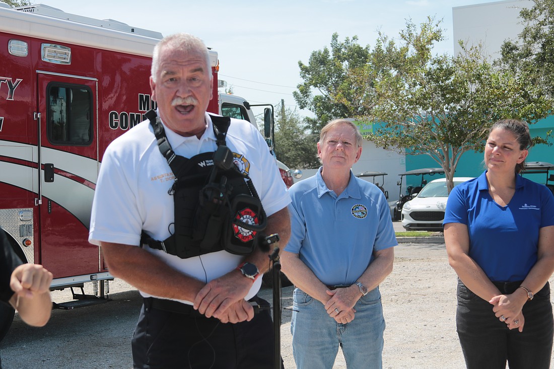 Sarasota County Assistant Fire Chief Tom Dorsey speaks at a news conference on Siesta Key on Friday, Sept. 27, while County Commissioner Mark Smith and Sarasota County Emergency Management Chief Sandra Tapfumaneyi look on.