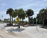 Benjamin Franklin Drive on Lido Key was left covered in sand after storm surge from Hurricane Helene swept the road.