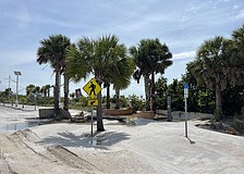 Benjamin Franklin Drive on Lido Key was left covered in sand after storm surge from Hurricane Helene swept the road.