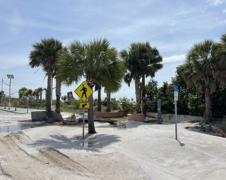 Benjamin Franklin Drive on Lido Key was left covered in sand after storm surge from Hurricane Helene swept the road.
