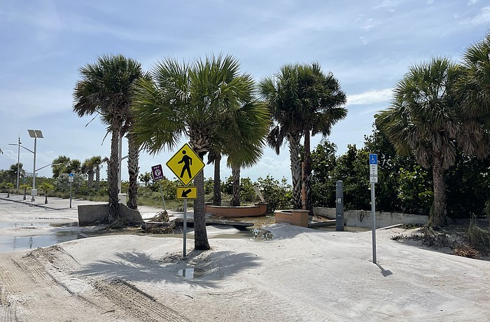 Benjamin Franklin Drive on Lido Key was left covered in sand after storm surge from Hurricane Helene swept the road.
