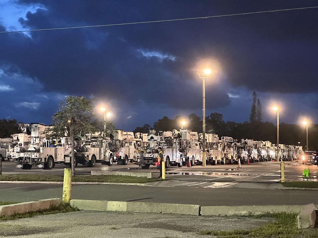 Truck are lined up at the Sarasota County Fairgrounds at dawn Friday, Sept. 27, 2024 as Florida Power & Light coordinated efforts to restore power to residents after Hurricane Helene.