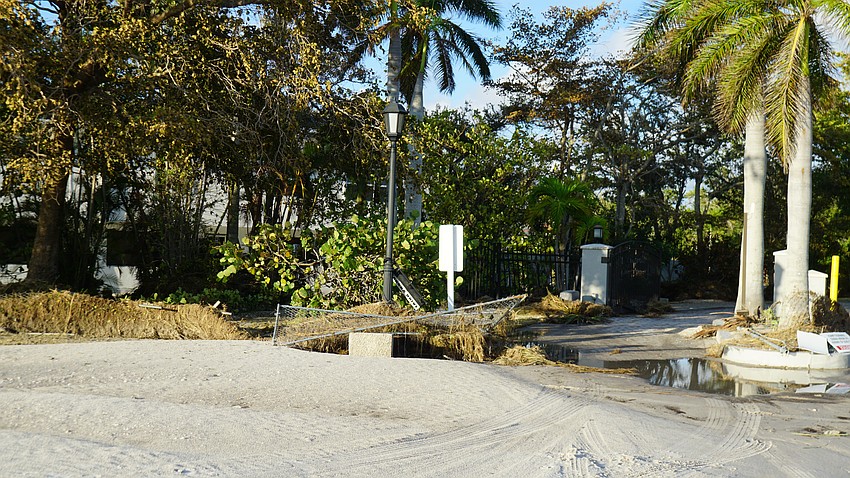 Hurricane Helene's storm surge and wind knocked down street signs and fences and damaged roads extensively in some areas.
