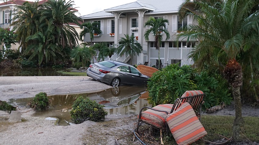 Debris like couches can be seen along Gulf of Mexico Drive, and some cars didn't survive the storm.