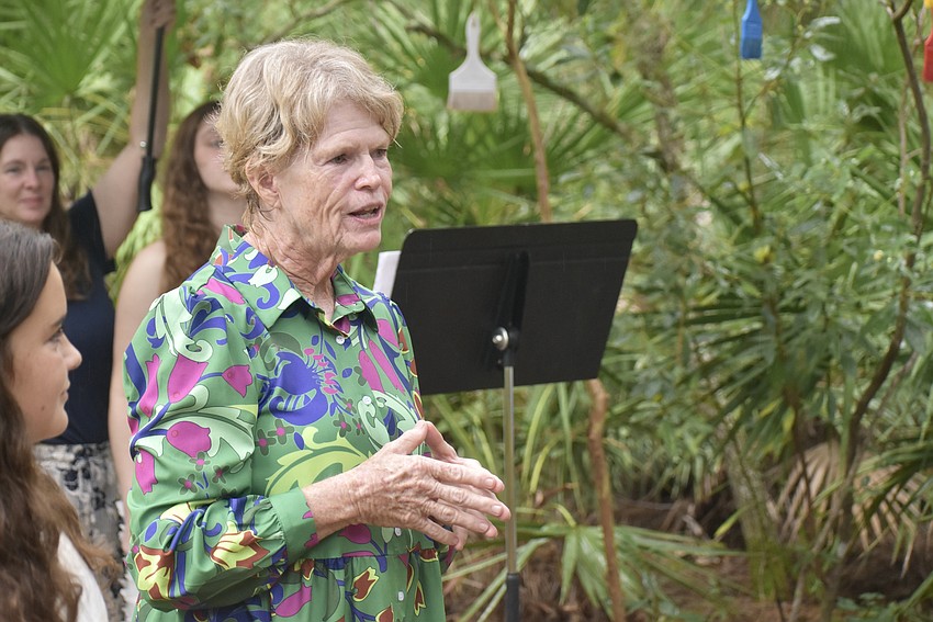 Church member Jamie Reagan speaks to the crowd ahead of unveling the artwork.