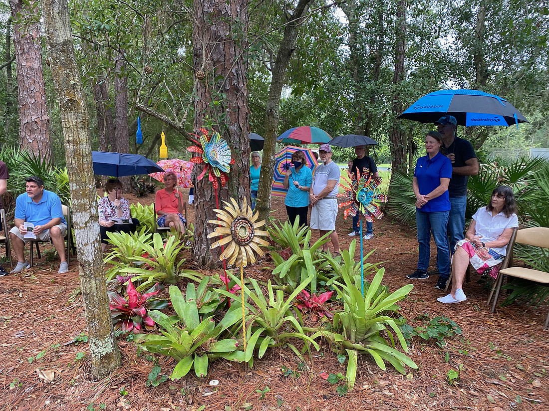 Guests gather at the entrance of the Peaceful Path at Peace Presbyterian Church for an art dedication on Sept. 28.