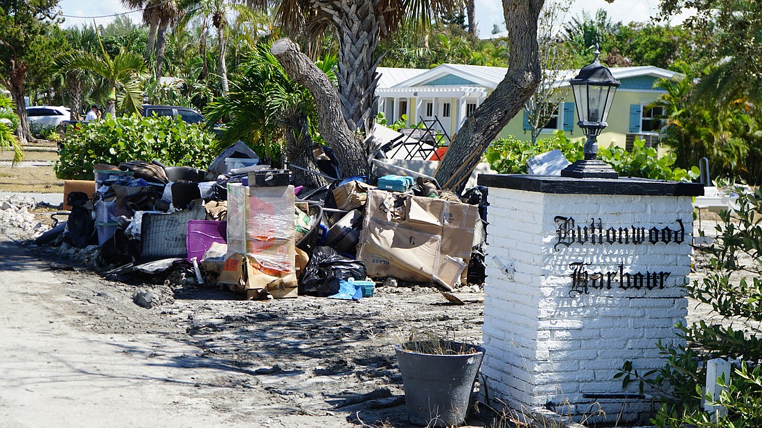 Buttonwood Harbour, one of the island's lowest-lying areas, had piles of debris stacked along the road.