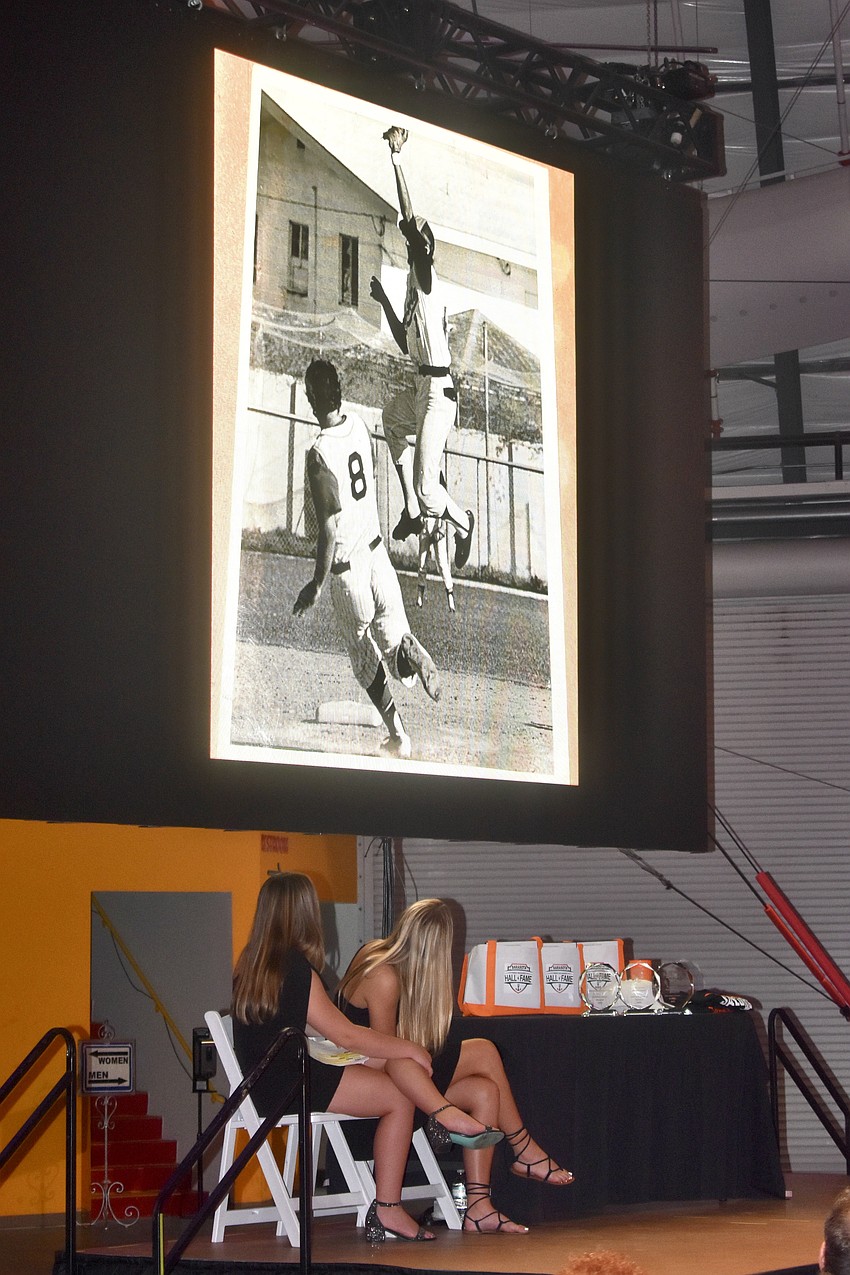 Harley Renner and Parker Mayforth look at an image of the 1973 State Champion Baseball Team.