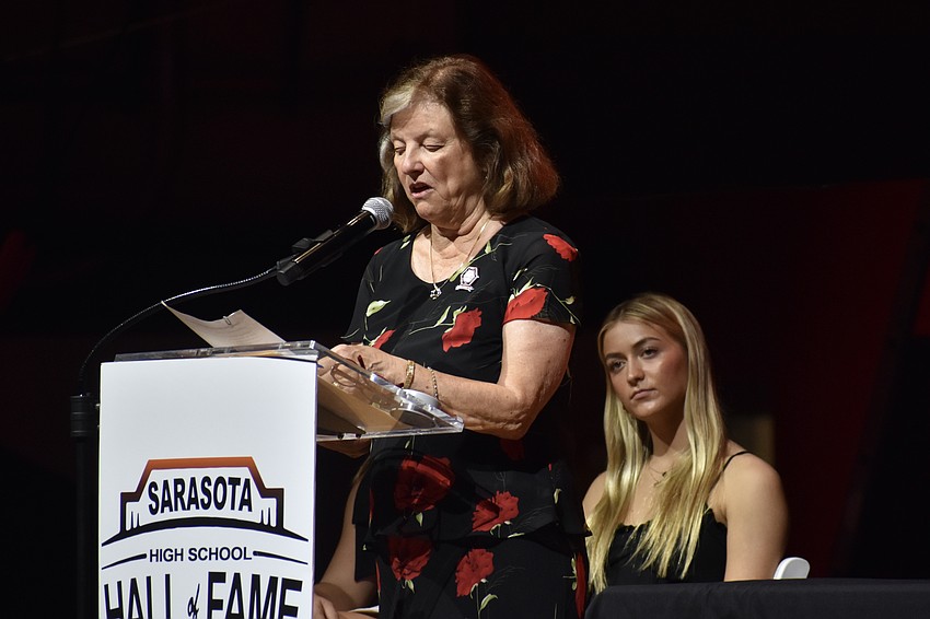 Sherri Tierney Reynolds speaks, with Sarasota High School student and presenter Parker Mayforth in back.