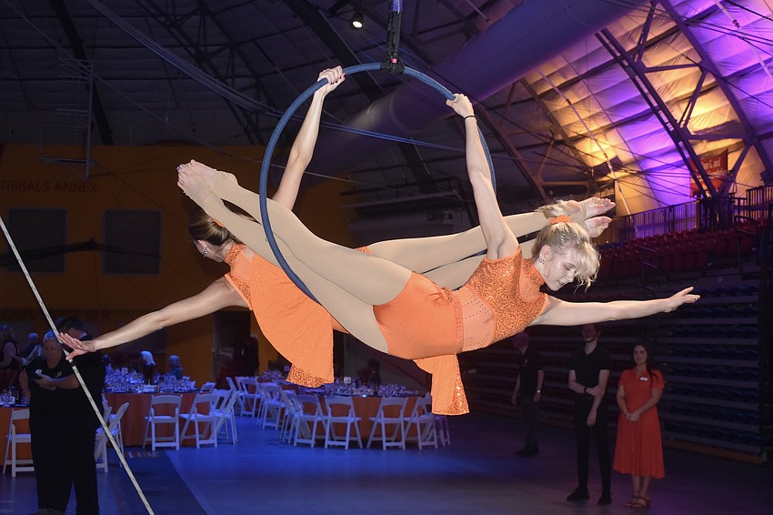 Sarasota High School seniors Lana Ledger and Rachael Parisi, students in the Circus Magnet Program, offer ambient entertainment.