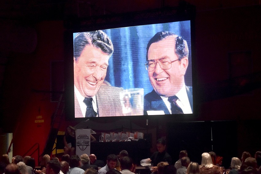 A slideshow plays in memoriam of Dr. Bob Windom, who was nominated by President Ronald Reagan and confirmed by the US Senate to serve as Assistant Secretary of Health in 1986. The awards was accepted by his son Ross Windom.
