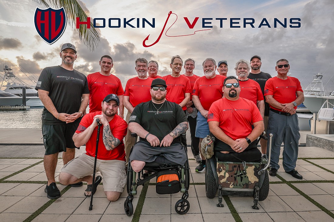 Veterans on a Hookin Veterans deep-sea fish retreat pose for a photo at Sailfish Marina in Palm Beach Shores. The organization's founders are wearing black T-shirts: Joseph "Booch" Buccini (left), Tyler Jeffries (front center) and Colby Briggs (back right). Two Palm Coast veterans on the trip were Bill May (third from left standing) and Ernie Morris (third from right standing). Courtesy photo.