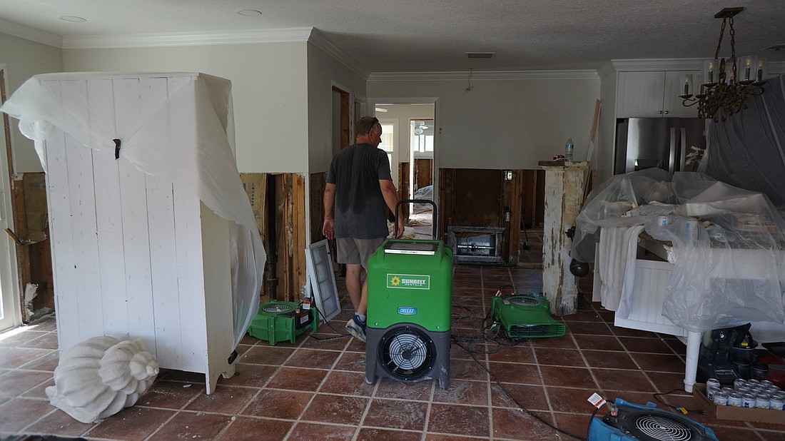 Chris Udermann and his wife, Susan, were working hard on Tuesday morning to clean their house and start necessary drywall removal after Hurricane Helene.