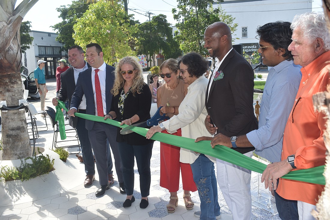 Deputy City Manager Patrick Robinson, Commissioner Erik Arroyo, Vice Mayor Jen Ahearn-Koch, Mayor Liz Alpert, commissioners Debbie Trice and Kyle Battie, DreamLarge CEO Anand Pallegar and resident David Lough were among those who cut the ribbon.