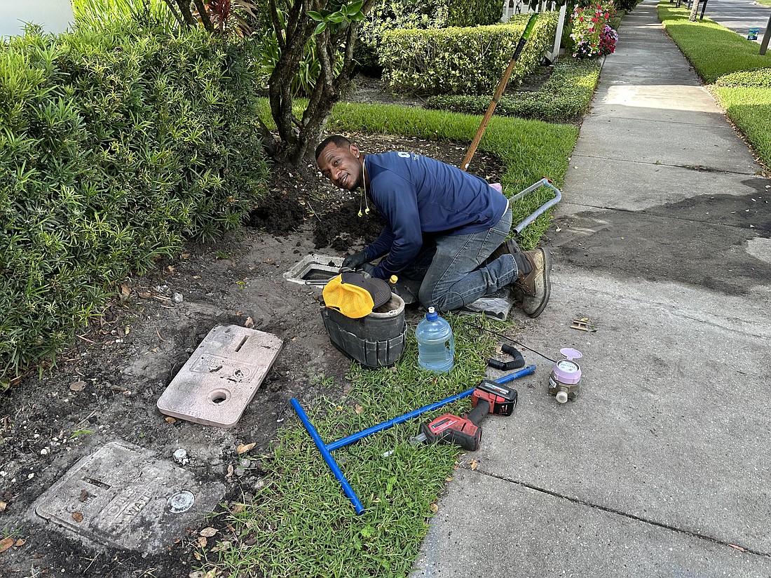 OUC Technician Lowell Gray replaces a reclaimed water meter with upgraded technology for a Baldwin Park resident. New water meters have an analog screen but can be read remotely by OUC services staff.  OUC has contracted with Utility Partners of America to upgrade its water and reclaimed water meters. According to Eddie Fee, of OUC, technicians already have completed an estimated 80% of meter exchanges in Baldwin Park.