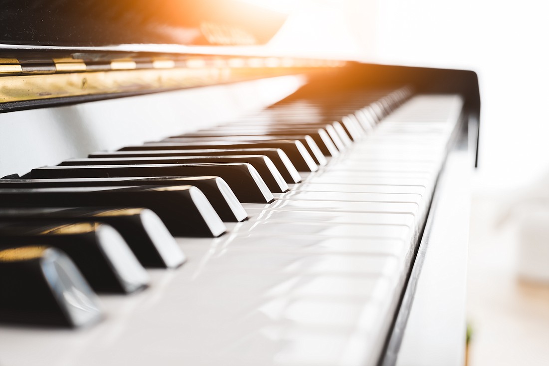 Classic piano key with musician hands playing