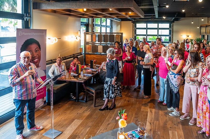 Dennis Rees addresses the group of attendees.