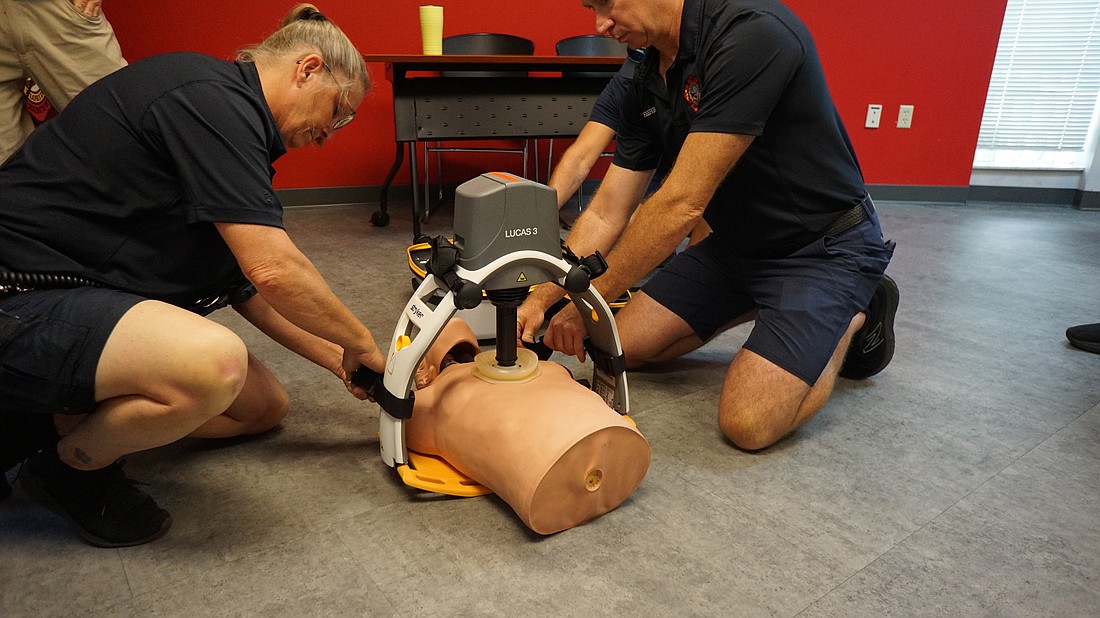 Lieutenant Kerri Brooks and Firefighter Paramedic Jay Gosnell demonstrate the Lucas 3 CPR device.