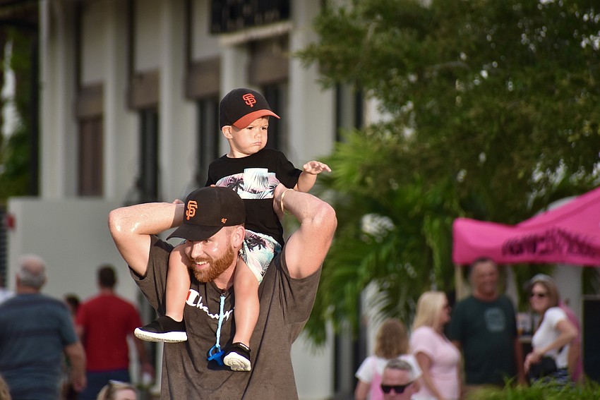 Easton Wells, 2, taps his uncle Noah Proffitt's arm with the music as they dance around to the Jesse Daniels Band.