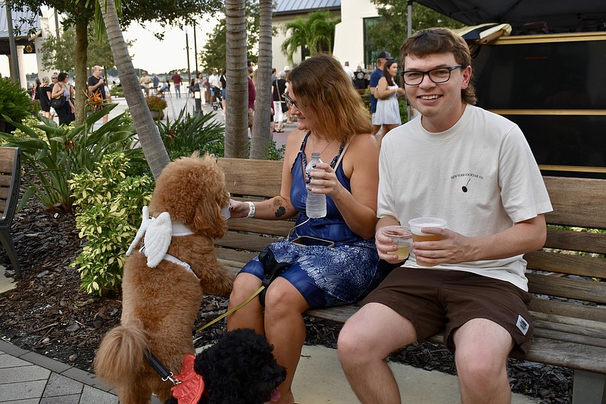 Lakewood Ranch residents Melissa Schlake, Dalton Vestal, Delilah and Lorelai all stop to have a drink. Schlake said the angel and devil wings on the dogs were handed out accordingly.