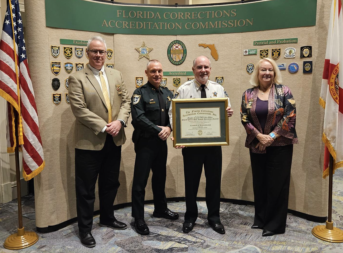 FCAC Executive Director Stacy Lehman (far left) and chair of the Board of Commissioners Chief Laura Bedard (far right) award FCSO Chief Daniel Engert and Sheriff Rick Staly the Certificate of Reaccreditation. Courtesy of the FCSO