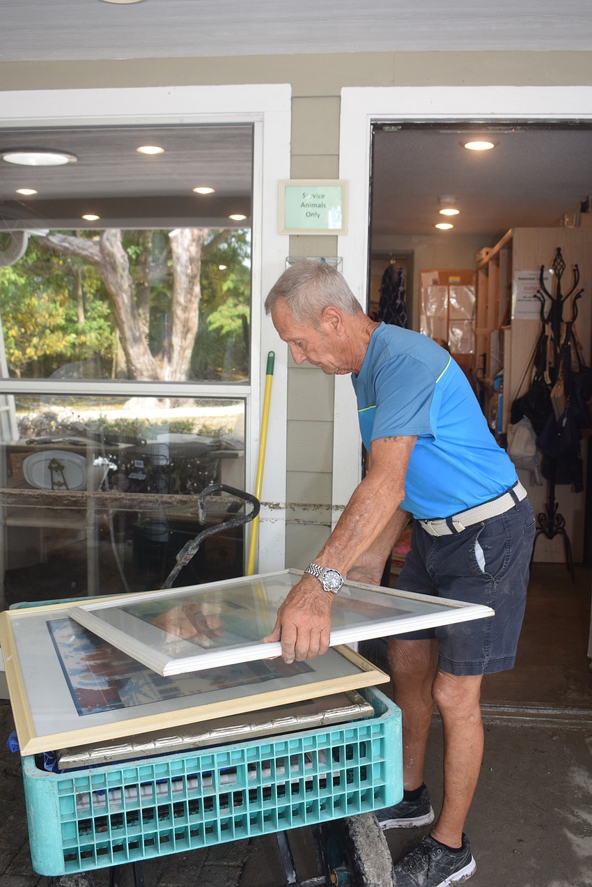 Bob Mazurak storing paintings from the Lord's Warehouse after Hurricane Helene.