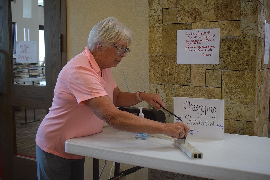 Barbara Grimes setting up a radio at the comfort station at Christ Church of Longboat Key.