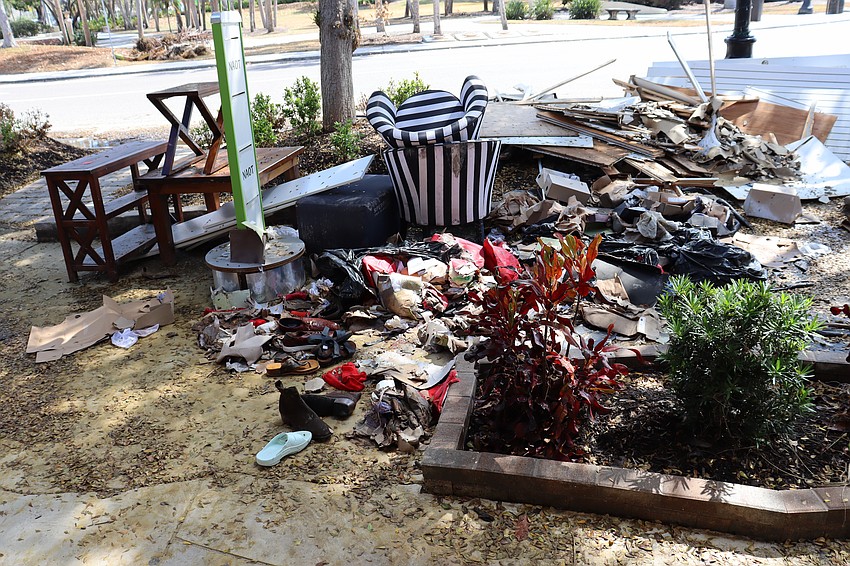 Ruined shoes and other inventory outside a boutique is piled up on the sidwalk at St. Armands Circle.