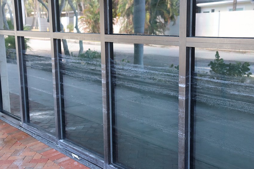 The salt line on the windows of this St. Armands storefront shows the high water mark of the Hurricane Helene storm surge.