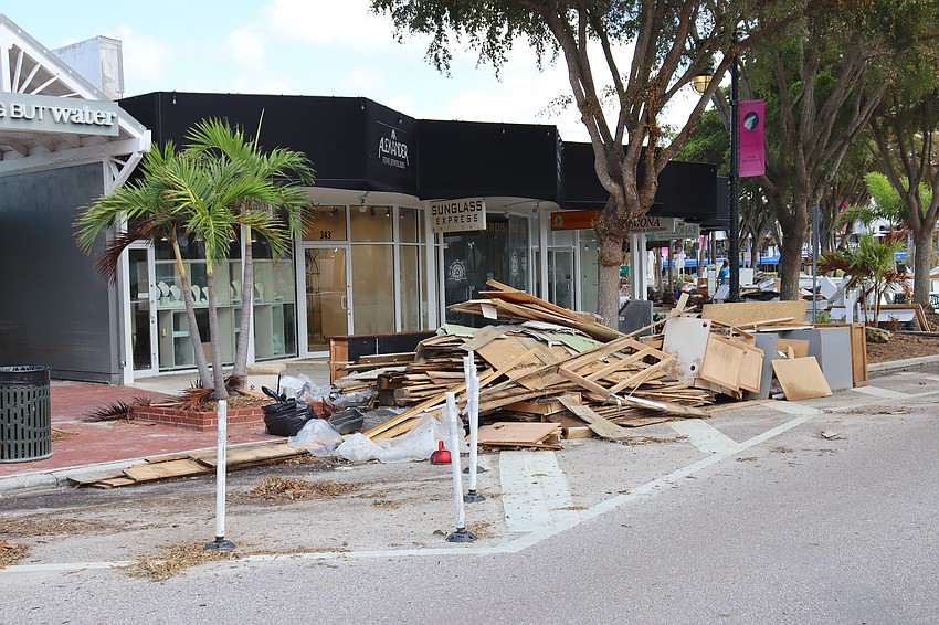 Hurricane Helene ebris awaits removal at St. Armands Circle. Because commercial debris is not eligible for FEMA reimbursement to the city and county, the removal is the responsibility of the merchants.