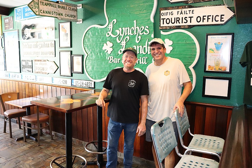 Lynches Pub owner Jason Burns (left) and St. Armands Residents Association President Chris Goglia inside the pub, one of the first restaurants at St. Armands Circle to reopen after Hurricane Helene.