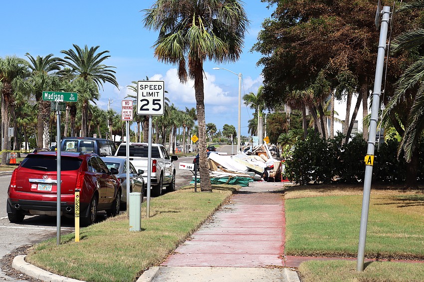 Residential debris is piled up on the sidewalk on Boulevard of the Presidents just north of St. Armands Circle.