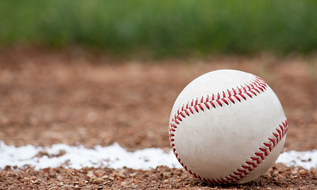 Close-up of a baseball sitting near the foul line