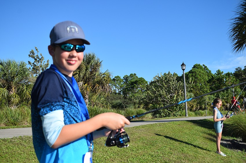 After seeing a fish jump in the water, Mill Creek's Jackson Flora runs to cast his line to where he saw the fish.