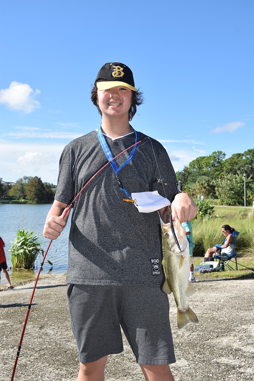 Lakewood Ranch's Kevin Anderson celebrates catching his first fish after seven years of participating in the Youth and Teen Fishing Tournament.