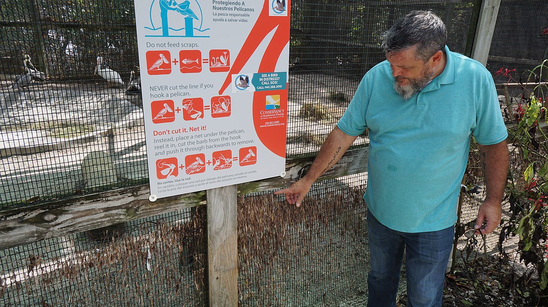 Brian Walton points to the water line left on some of the bird enclosures closer to the water. These are occupied by water-tolerant birds like pelicans and cormorants.