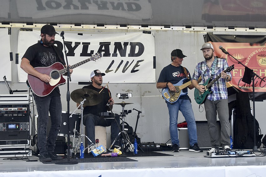 Pete Tamburen, Scott Serbin, Mark Serbin and Ben Shinrock perform on stage.