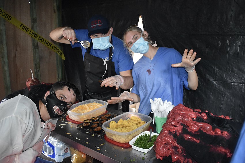 Englewood firefighters Darin Rasmussen, Landon Basore and Falynne Gainvors offered a gruesome surprise, serving chili from inside a severed zombie.