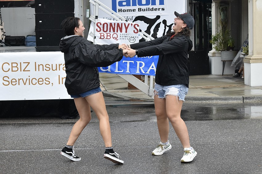 Best friends Alix Urban and Mackenzie Riley dance to the live music.