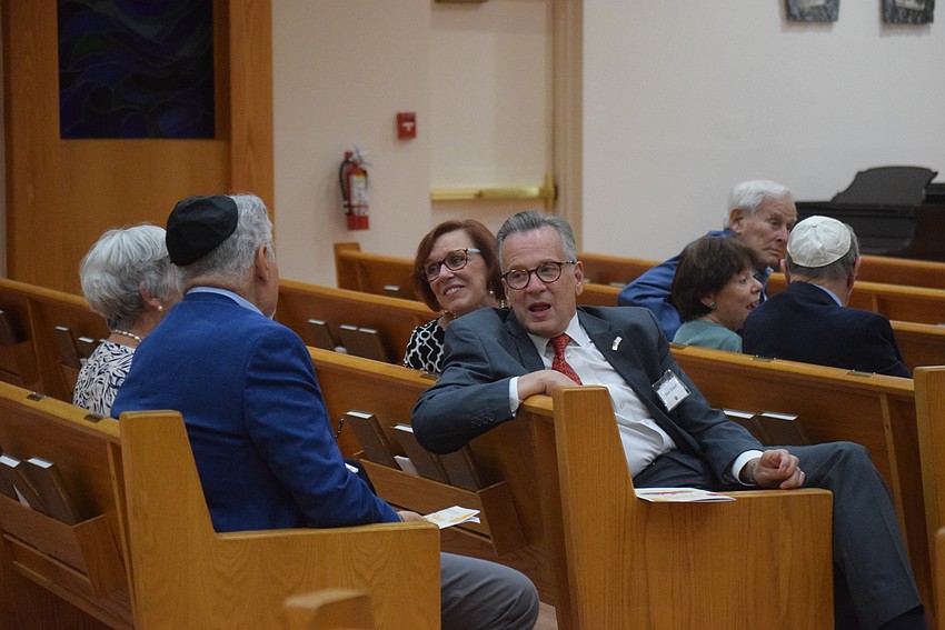 Jason and Mindy Brandt catching up with friends at the Rosh Hashanah service at Temple Beth Israel.
