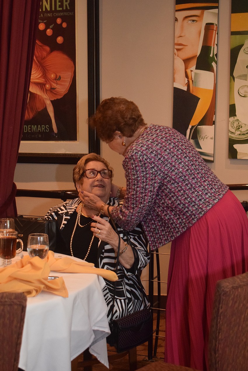 Elise Galinsky and Joyce Cooper greeting each other at the Rosh Hashanah luncheon.
