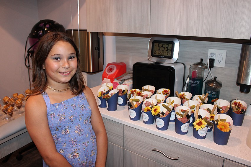 Mya Medford, the daughter of Sirius Day Spa owner Karen Medford, gets ready to pick out a snack at the spa's sixth anniversary party.