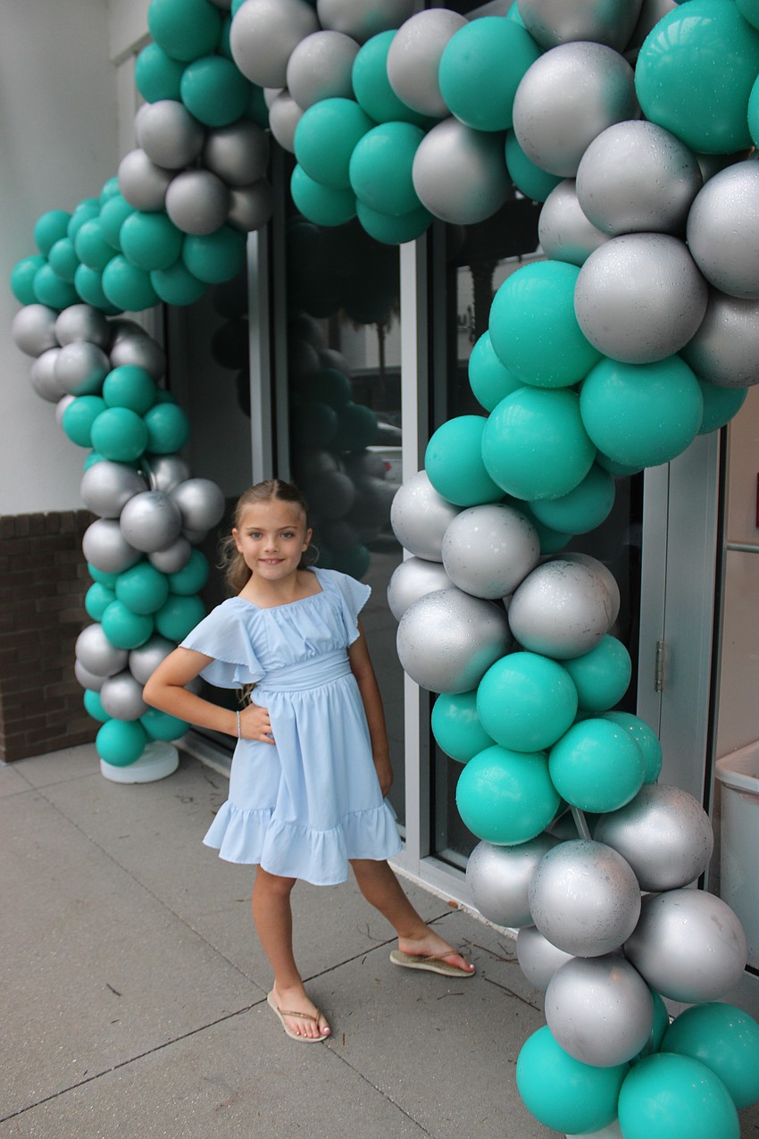 Eight-year-old Amilia Dragovoy is loving the balloons set up by the Sirius Day Spa for its sixth anniversary party in Lakewood Ranch.