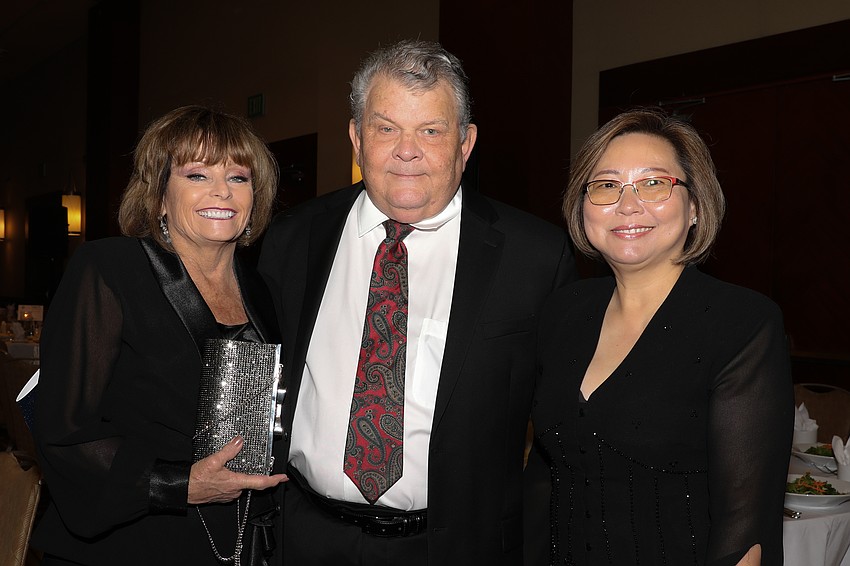 Donna Rabits, Dr. William Bell, and Vice Dean of the Dental School Dr. Katie Dinh