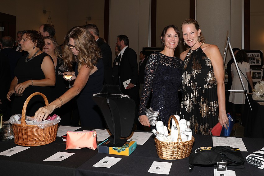 From State College of Florida are Heather Hernandez and Amanda Schlachter, who are perusing some of the hundreds of auction items. available